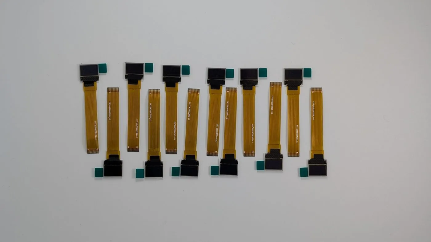 A row of 0.42-inch OLED modules laid out, each with its FPC tail extended
