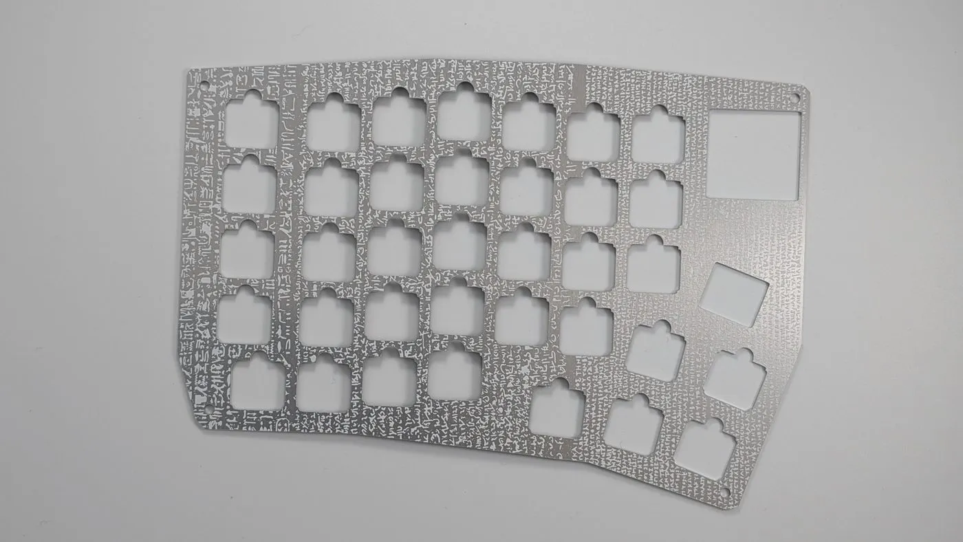 Aluminum plate for one half, with the square switch cutouts and the larger expansion-slot opening