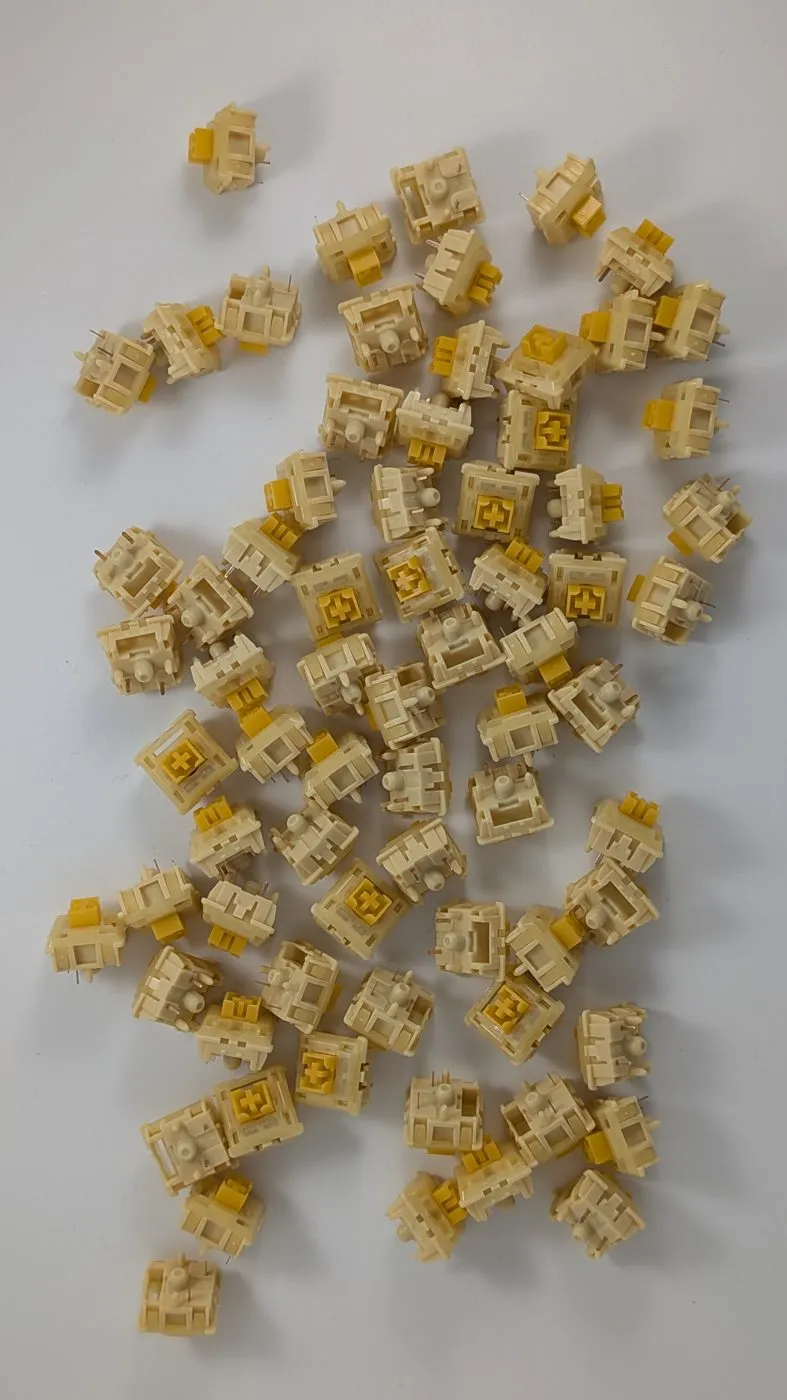 A pile of loose MX-compatible switches, LED slit facing up